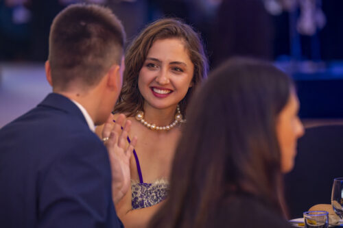 a woman smiles at the person next to her