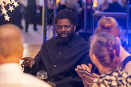 a man talking to other people