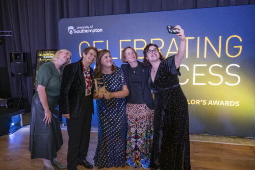 a group of people post for a selfie