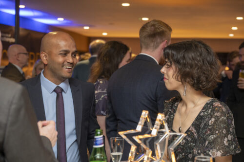 two people smiling and talking to one another