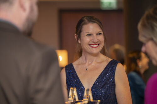 a woman smiles at the person next to her