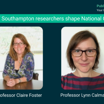 Two brunette woman with glasses, the one on the left is sat at a table, and the one on the right is wearing a striped top.