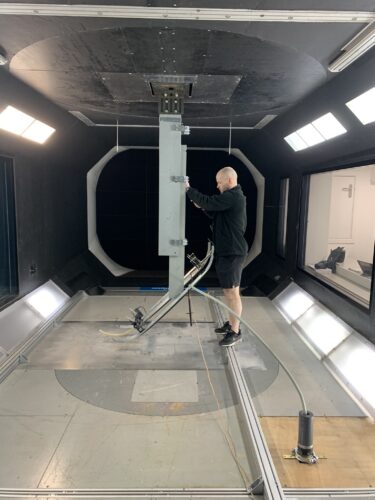 Charlie Reed, TDHVL Commercial Test Engineer, setting up a pantograph inside the RJ Mitchel Wind Tunnel to determine if different wind speeds affect the electrical breakdown clearances.