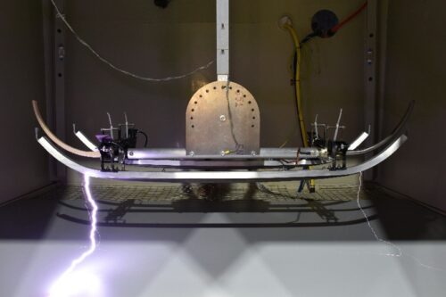 Testing to determine the electrical clearance between a pantograph and a simulated Insulated Bridge Structure.
