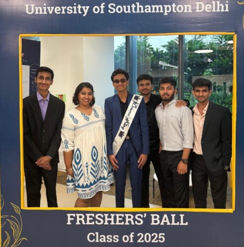 Members of staff posing with the picture frame at the Delhi freshers' Ball